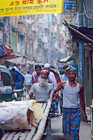 Pushing a cart down Hindu Street