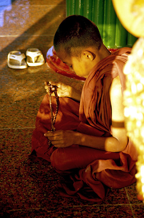 Young monk praying at Sule Pagoda