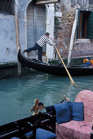 Gondolier pushing off the wall